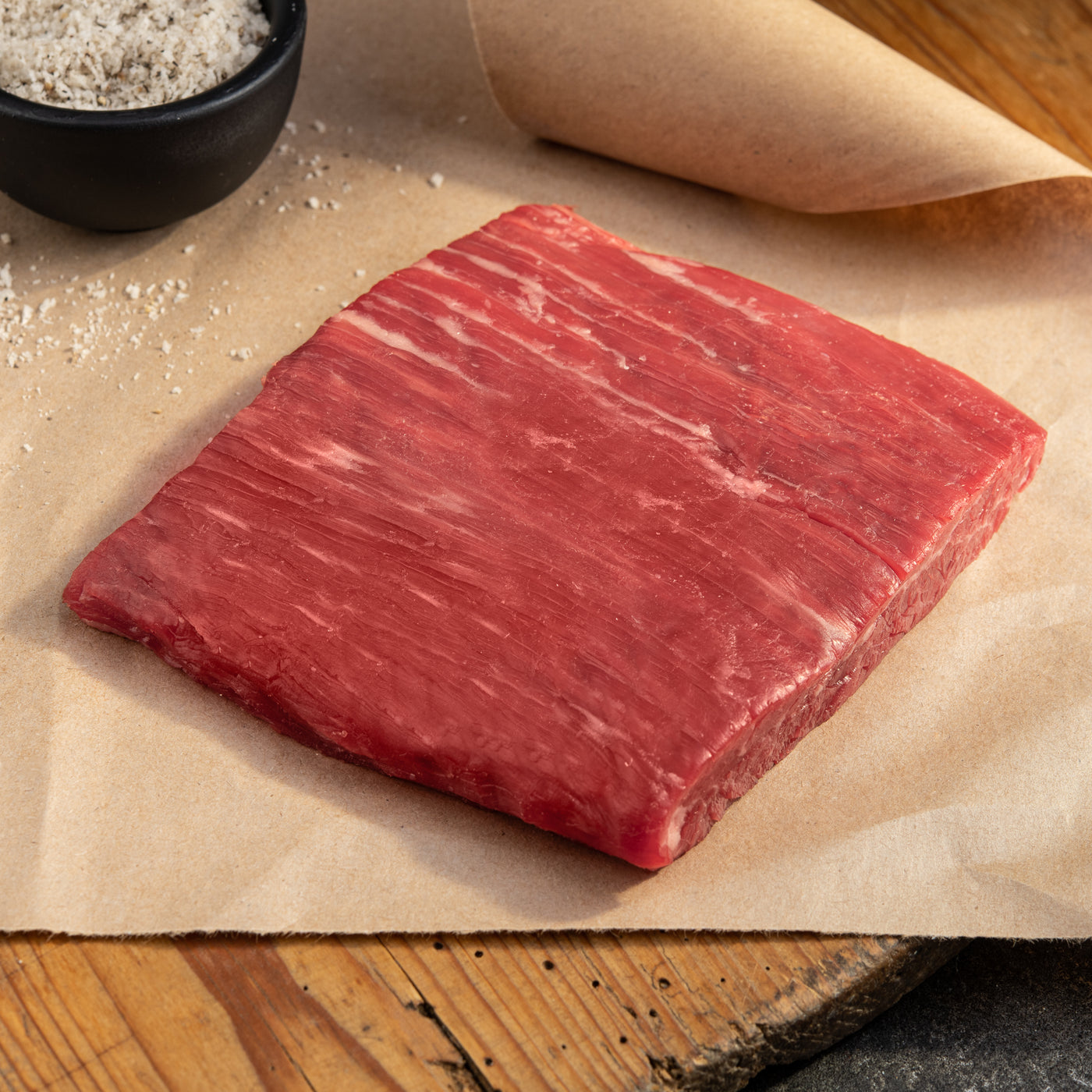 usda choice angus beef flank steak on parchment paper